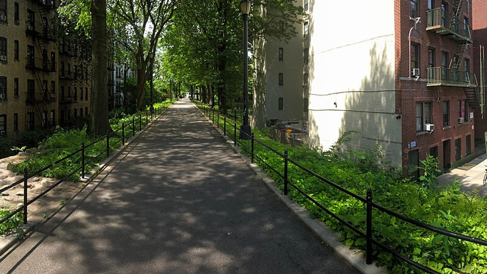 Walkway between apartment buildings and trees