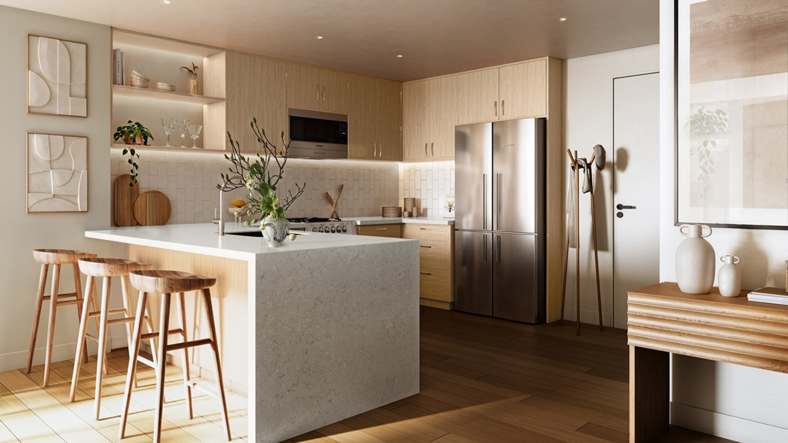 Rendering of an apartment kitchen with light wood cabinets, a stone-topped island with three stools, a stainless steel refrigerator and wood floors
