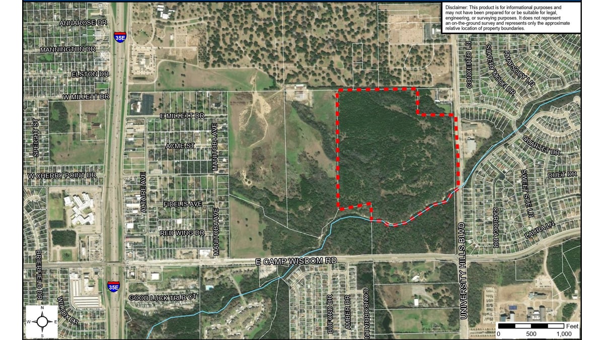 Aerial map with a red dashed boundary around wooded land north of East Camp Wisdom Road and west of University Hills Boulevard, with Interstate 35E to the west