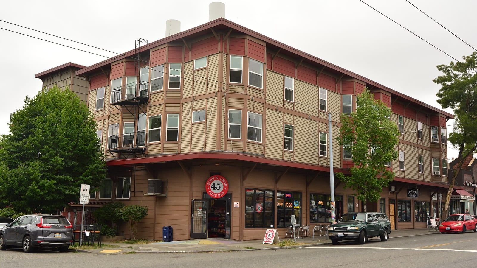 Corner apartment building with ground-floor storefronts