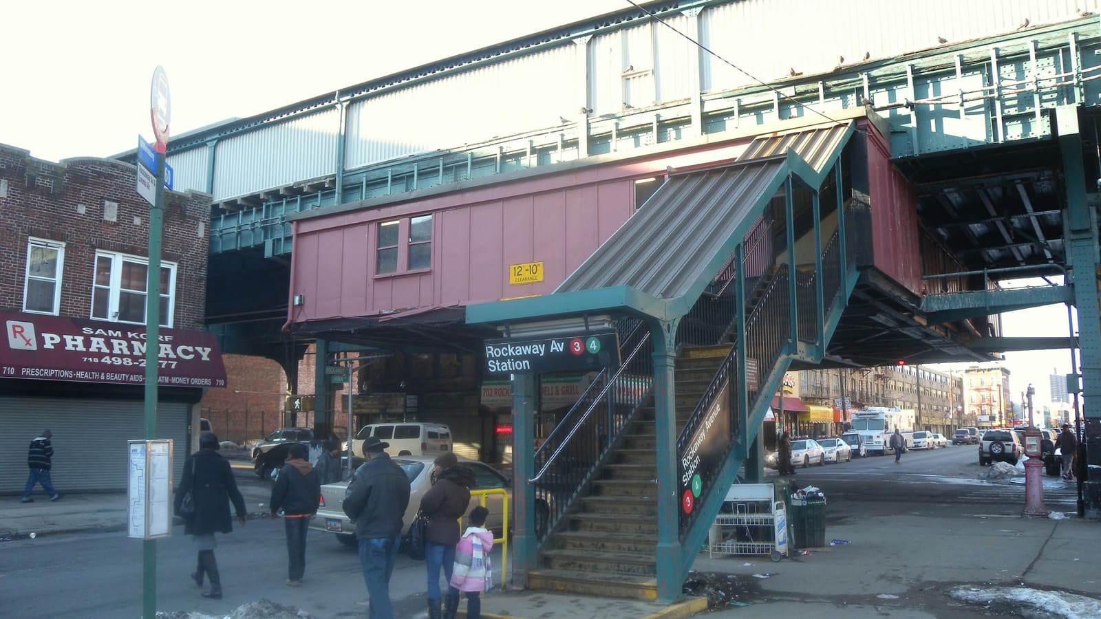 The street stair and elevated station house of the Rockaway Av station on the 3 line