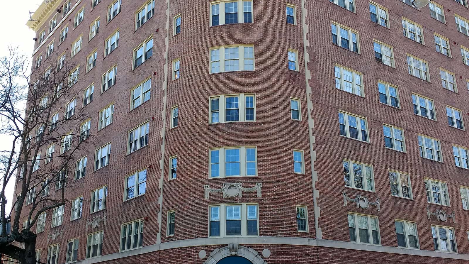 Brick apartment high-rise at a street corner