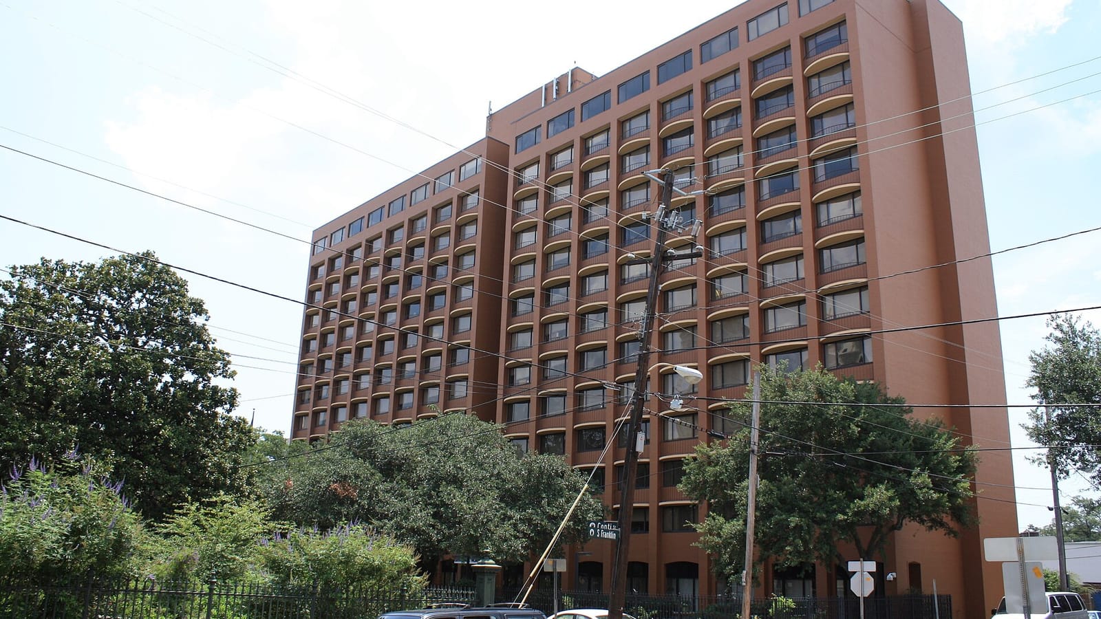 Red residential high-rise with arched windows