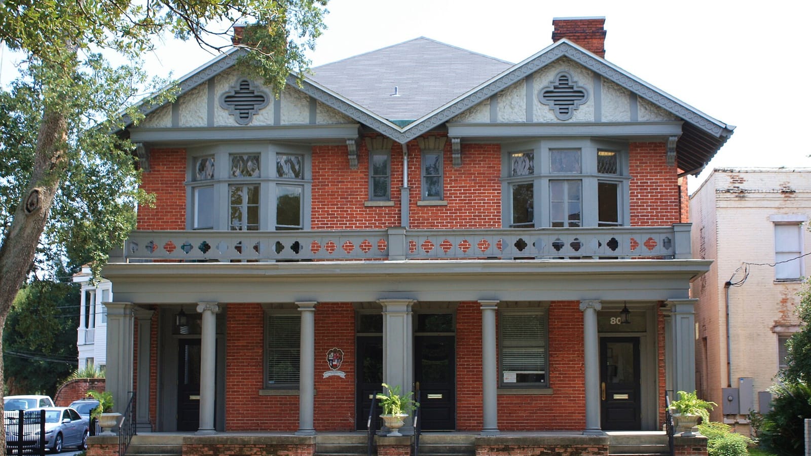 Red house with steep gables and a covered porch