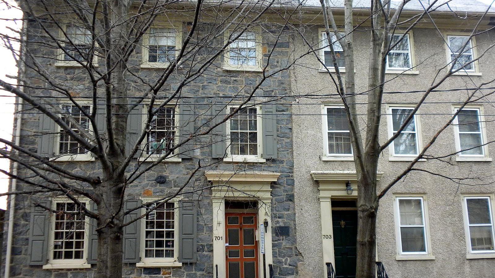 Gray rowhouse facades with tall windows