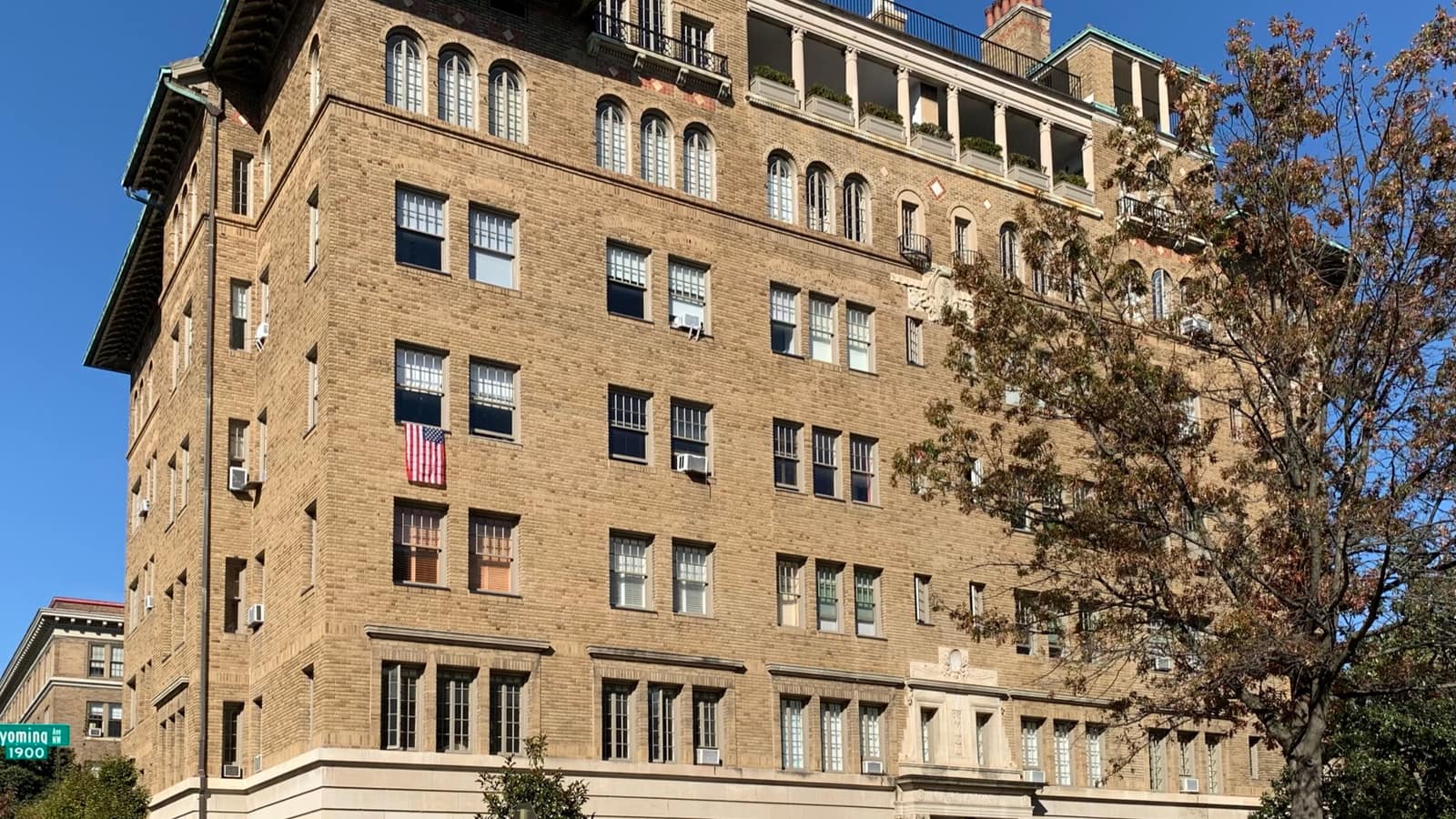 Yellow brick apartment building with projecting bays