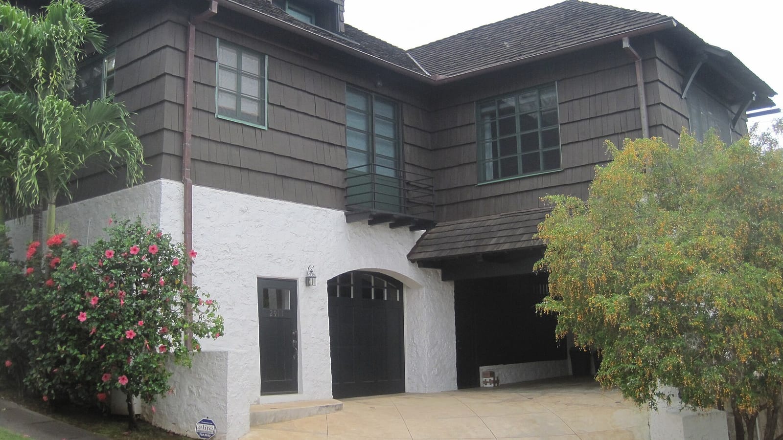 Wood-sided house with garage entrances
