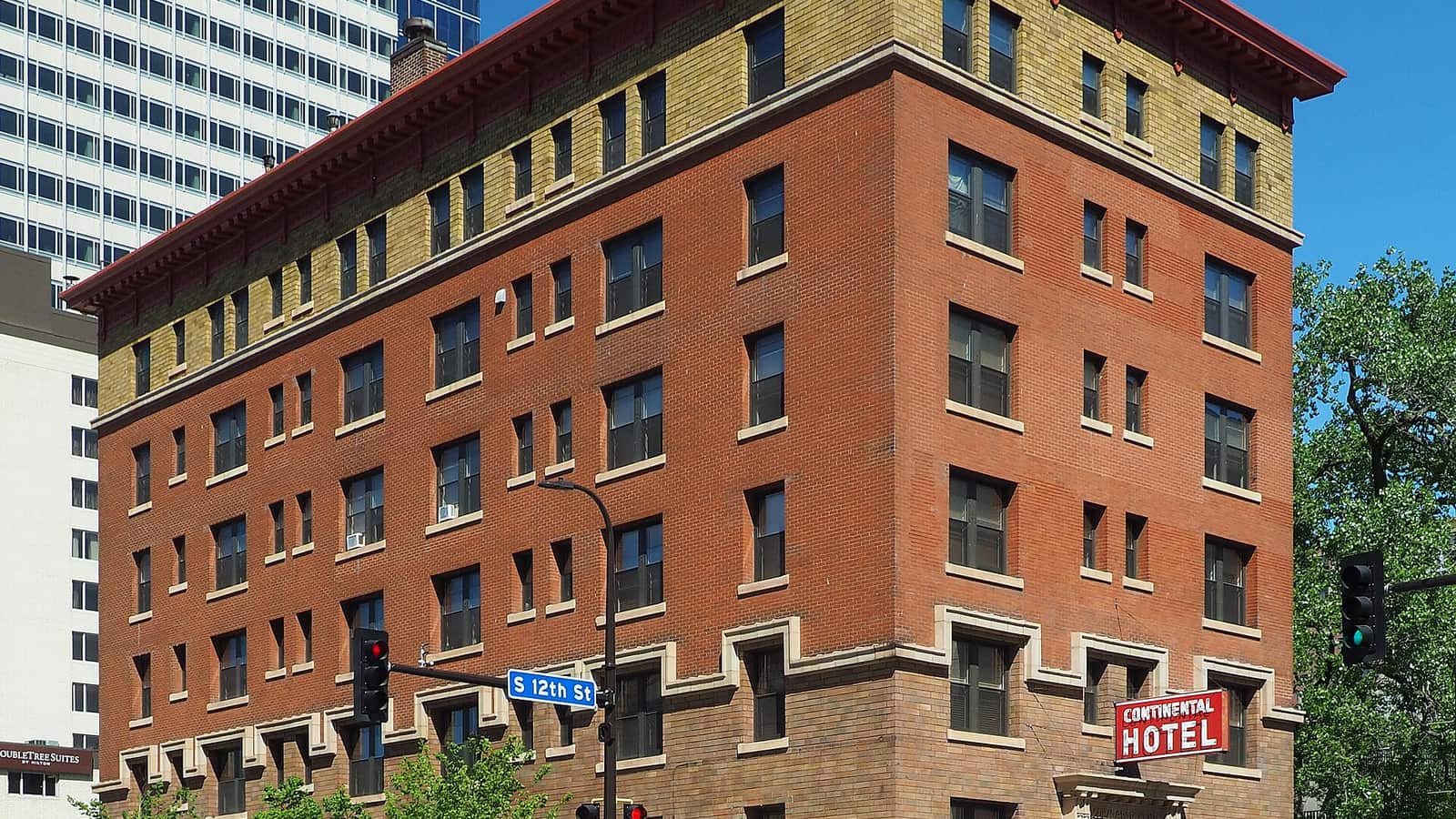 Red brick apartment hotel at a downtown intersection