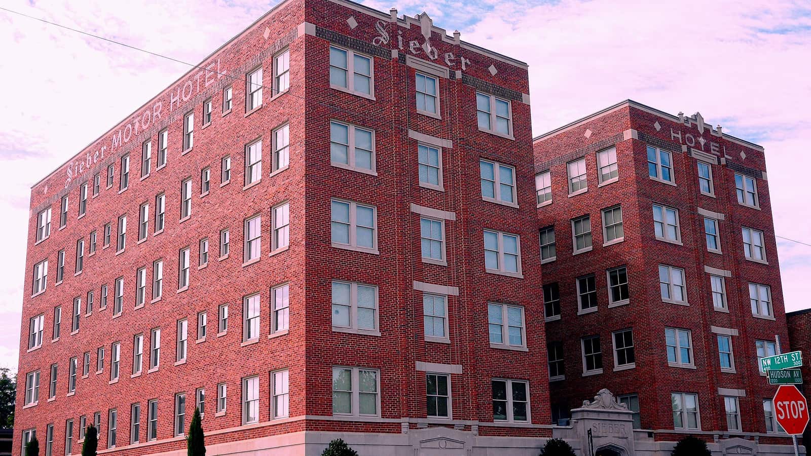 Red brick apartment hotel building at a street corner