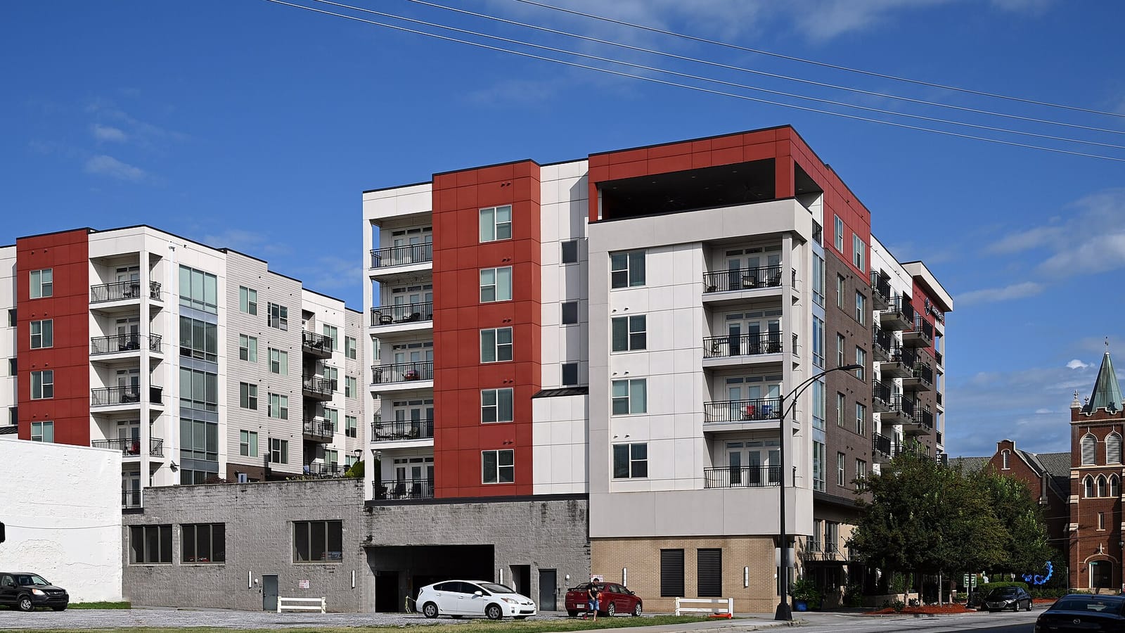 Modern apartment buildings with red and pale facade panels