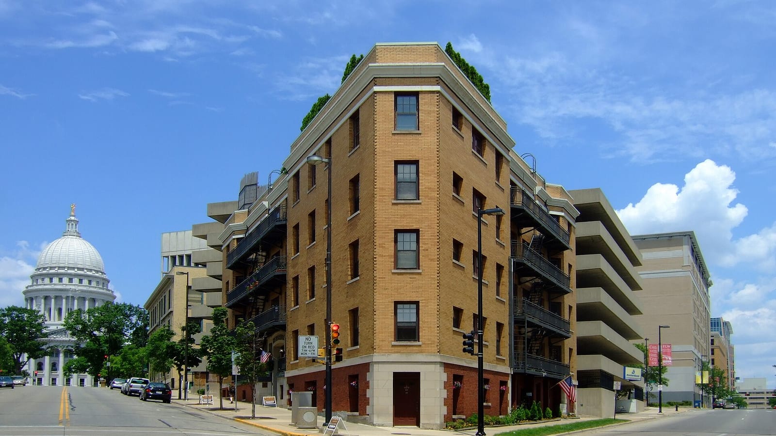 Tan apartment building at an intersection near the state capitol
