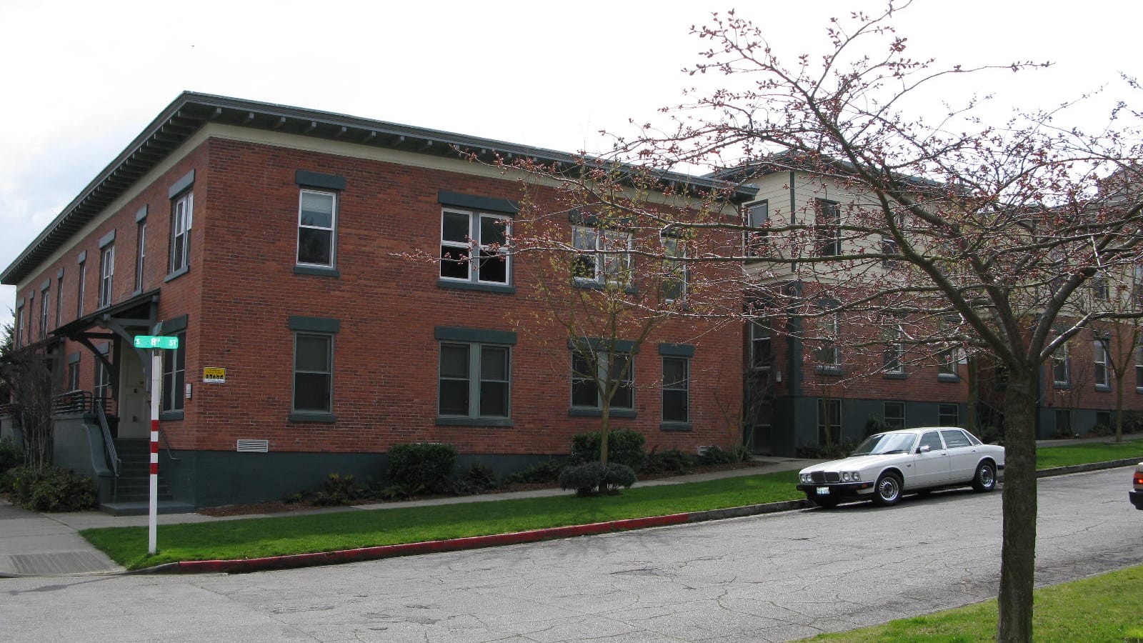 Low red brick apartments at a street corner