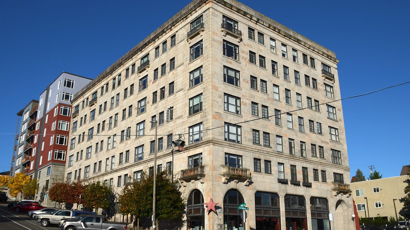 Pale brick apartment building with an arched entrance