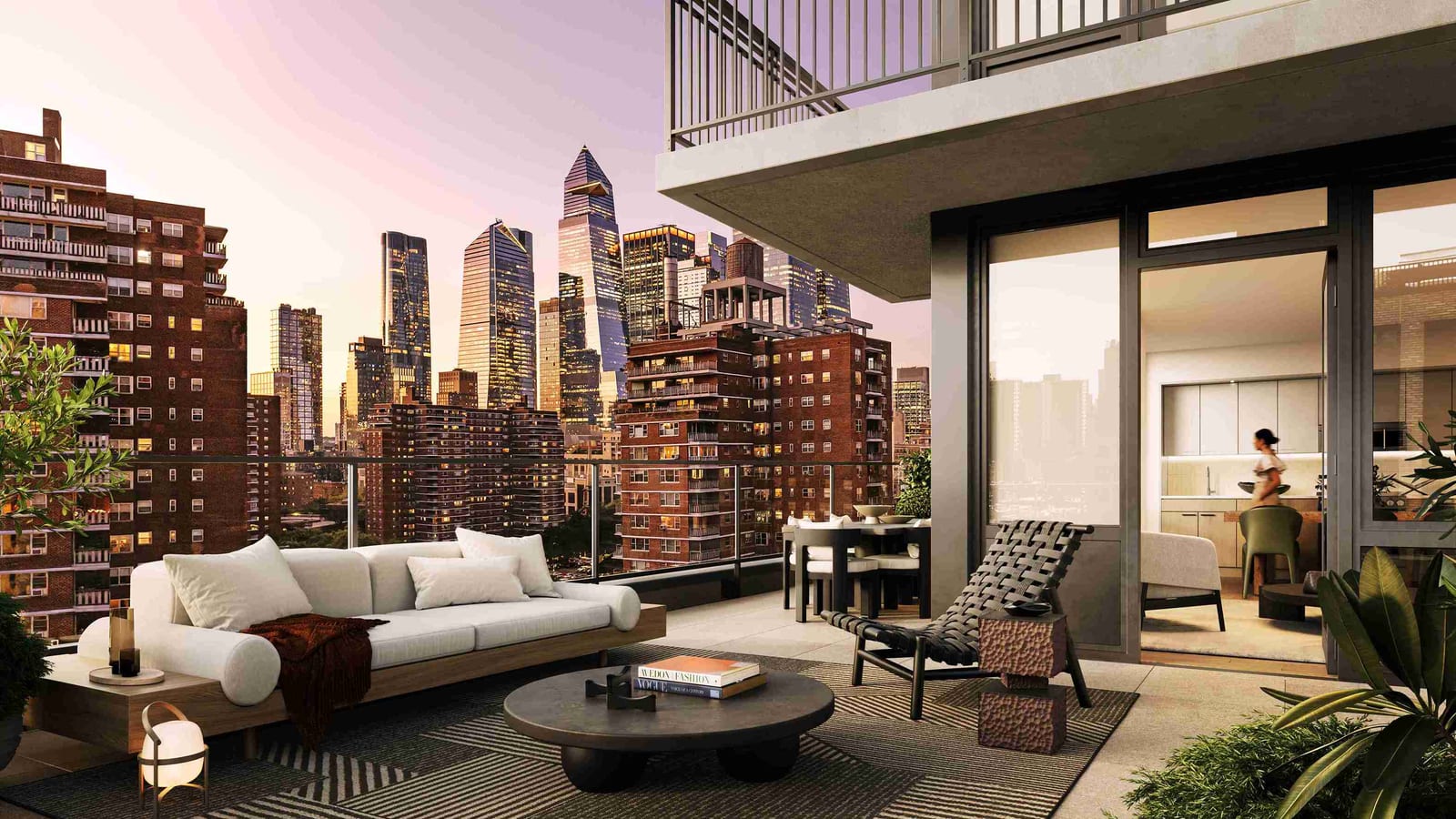 Rendering at dusk of a private terrace with a white sofa, a round coffee table and a lounge chair, glass doors into an apartment kitchen, and high-rise towers to the north