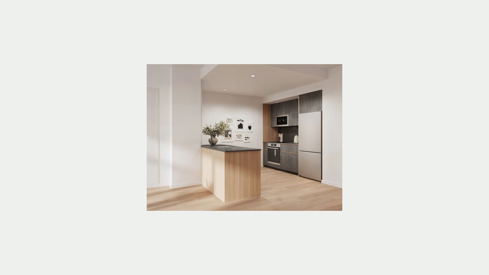 Rendering of an empty open kitchen with a light wood peninsula topped in dark stone with a black faucet, dark gray cabinets, a built-in microwave above a wall oven, a stainless-steel refrigerator, small framed prints on a white wall and light wood floors