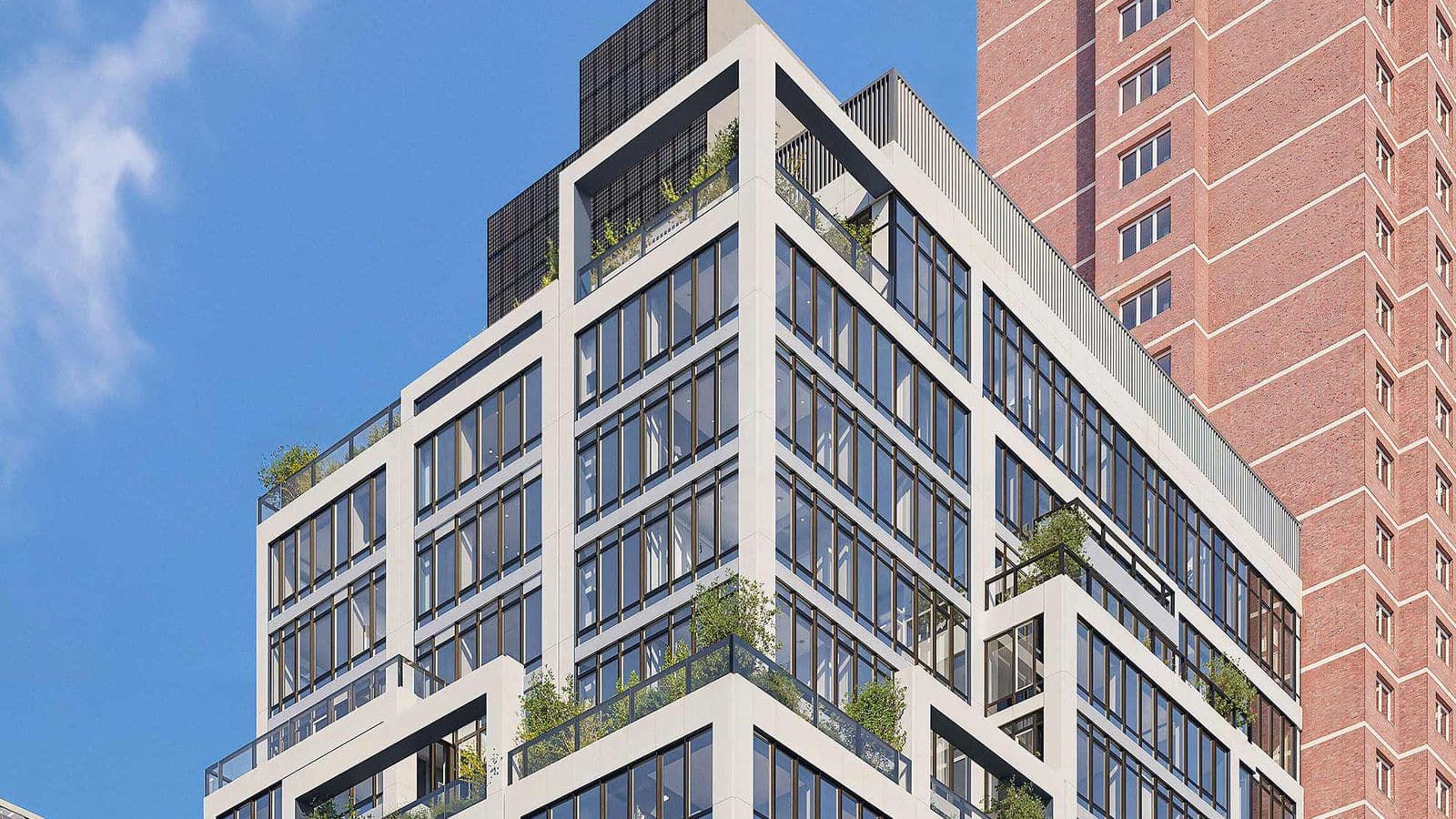 Rendering of the upper floors of a white-framed apartment tower with large dark windows, setbacks planted with greenery, glass railings and dark solar panels on the roof, beside a taller red brick tower under a blue sky