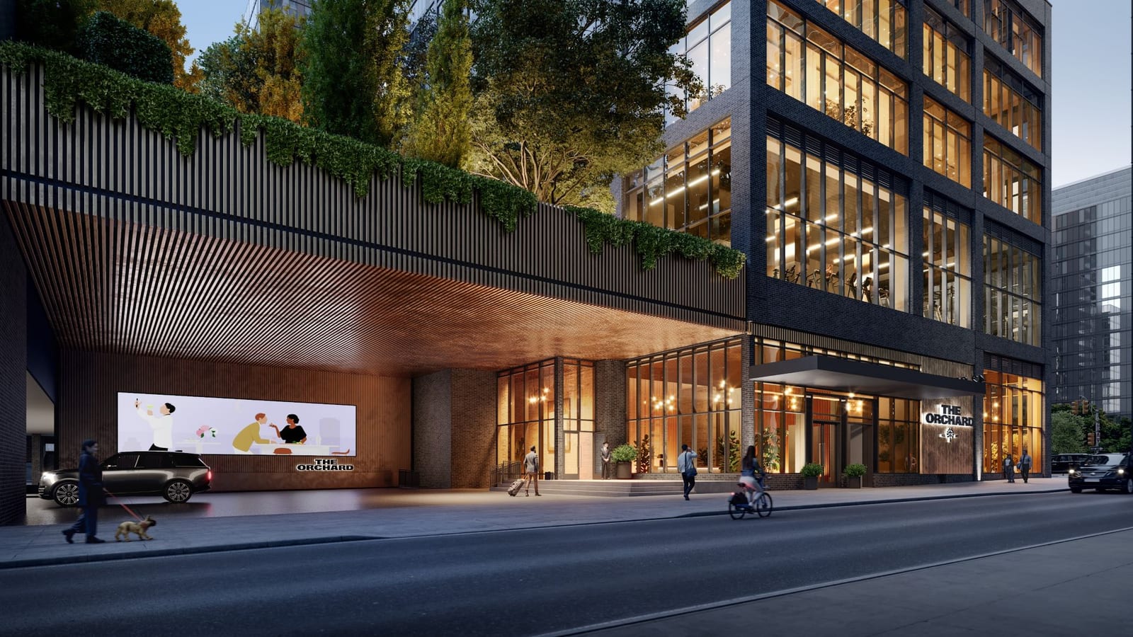 Rendering at dusk of the base of a dark brick and glass tower with THE ORCHARD lettering beside glass lobby doors, a wood-lined covered driveway at the left with a car and a lit mural, plants hanging over a slatted screen above it, and people walking and cycling along the street