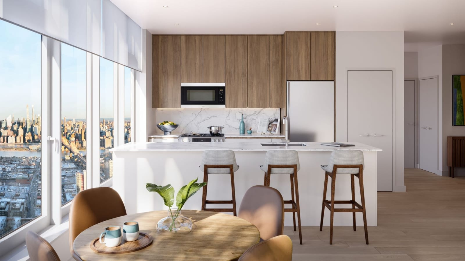 Rendering of a kitchen with wood-tone upper cabinets, a marble-look backsplash, a built-in microwave above a range with burner grates and a pot on it, a stainless-steel refrigerator, a white island with a sink and three stools, a round wooden table in the foreground and tall windows at the left looking over a city