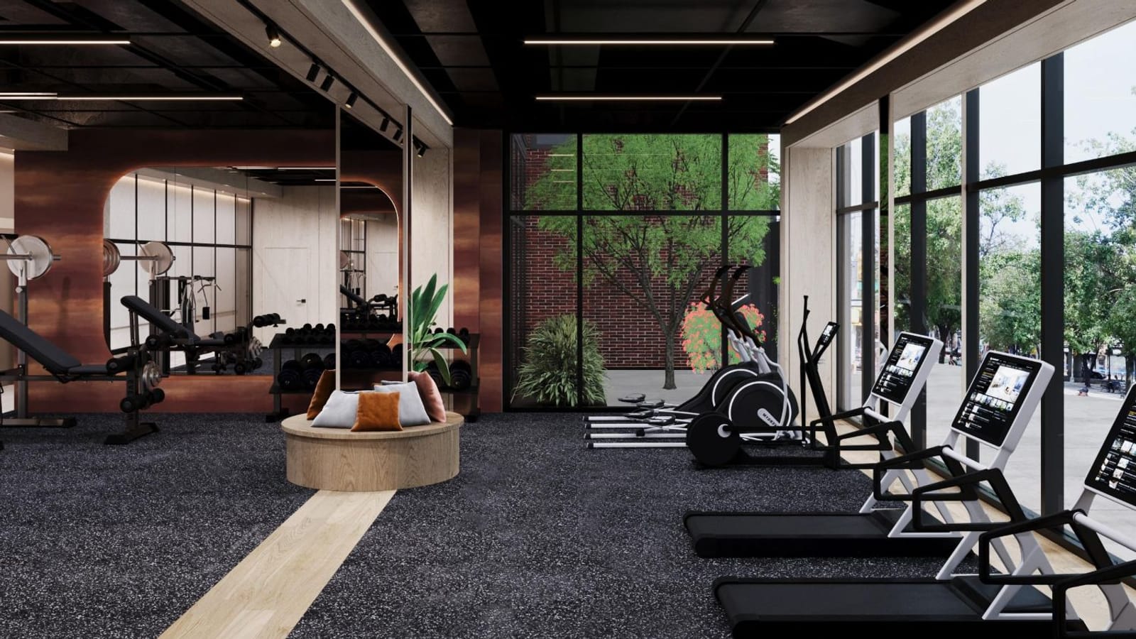 Rendering of a gym with treadmills and elliptical machines along floor-to-ceiling windows, a weight bench and dumbbell racks before a mirror wall, a round wooden seat with cushions and a small planted courtyard behind glass