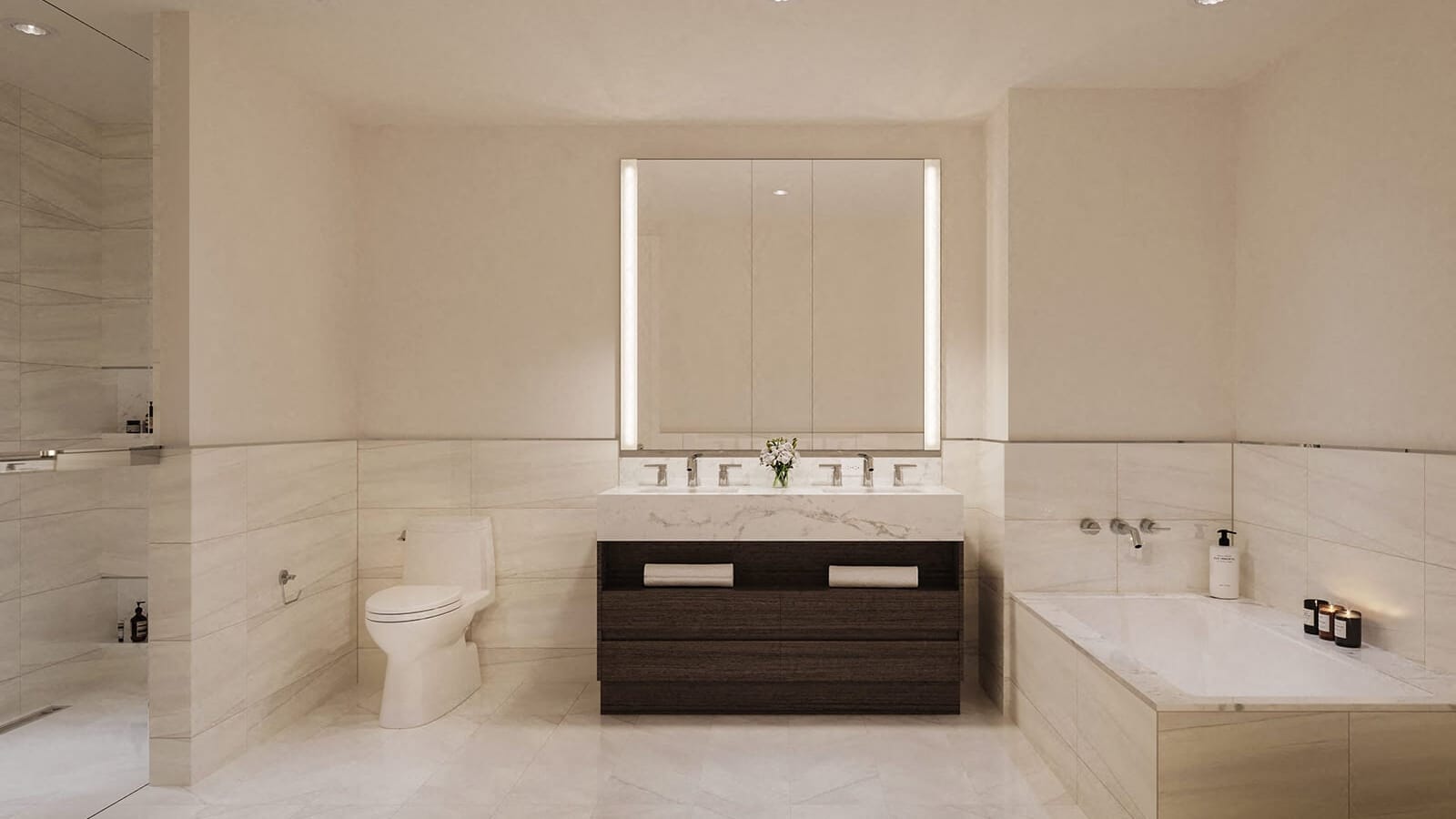 Rendering of a bathroom with pale porcelain tile on the lower walls and floor, a double-sink vanity with a dark wood base under a wide lit mirror cabinet, a toilet at left, a built-in bathtub at right and a glass shower at the far left