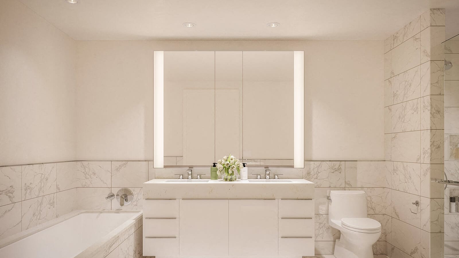 Rendering of a bathroom with pale marble tile, a double-sink white vanity under a wide lit mirror cabinet, a built-in bathtub at left, a toilet and a glass shower at right