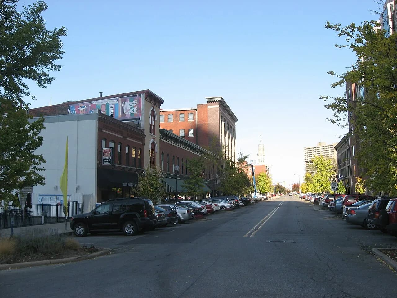 Brick commercial buildings and parked cars along Massachusetts Avenue in Indianapolis
