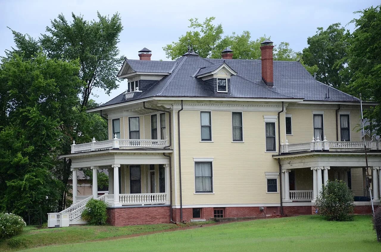Large wood-sided house with porches in Little Rock’s South Main Street Residential Historic District