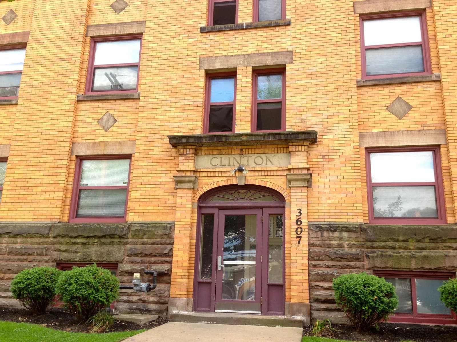 Brick facade and entrance of the historic Clinton Apartments in Cleveland’s Ohio City neighborhood