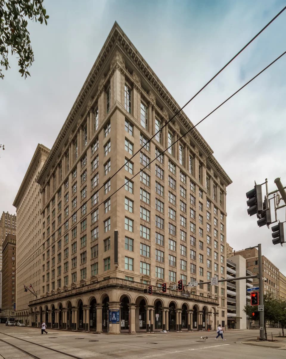 Historic brick and stone facade of The Star Apartments in downtown Houston