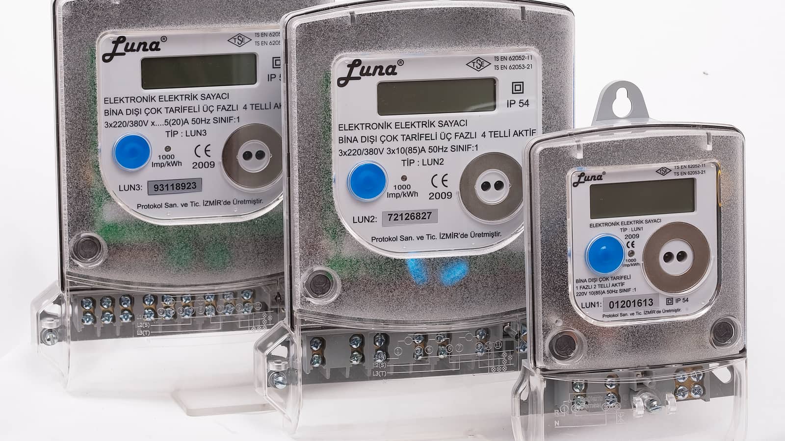 Three electronic electricity meters with digital displays and transparent terminal covers.