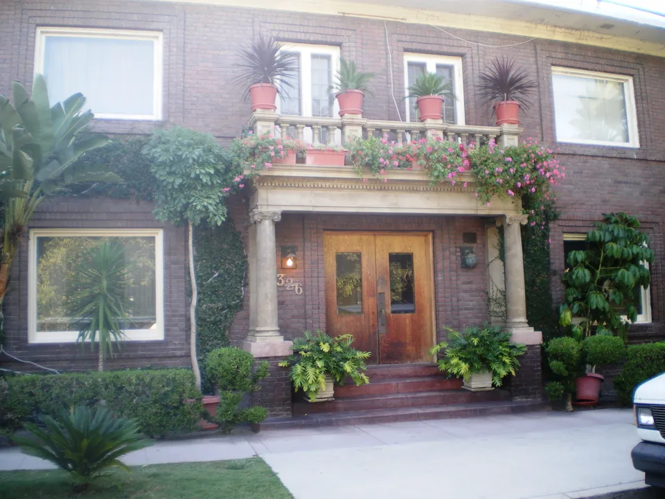 Brick facade, balconies and front entrance of Powers Apartment No. 2 in Los Angeles.