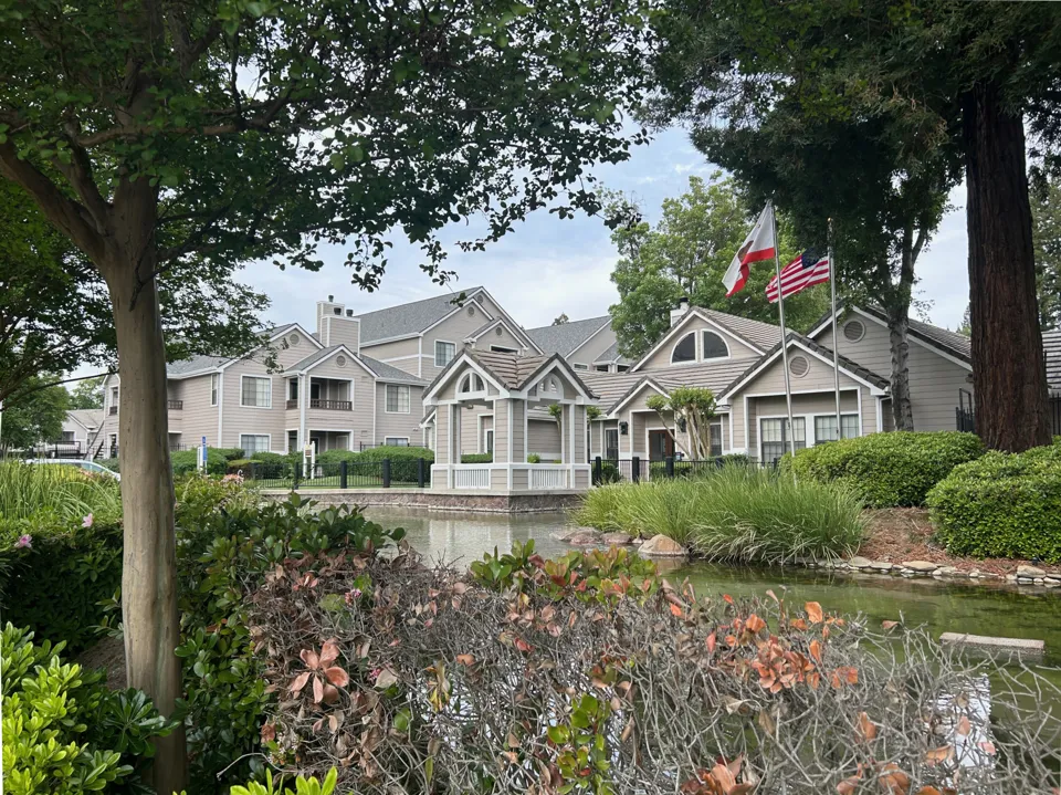 Low-rise buildings and landscaping at the Crossing at River Lake apartments in Sacramento.