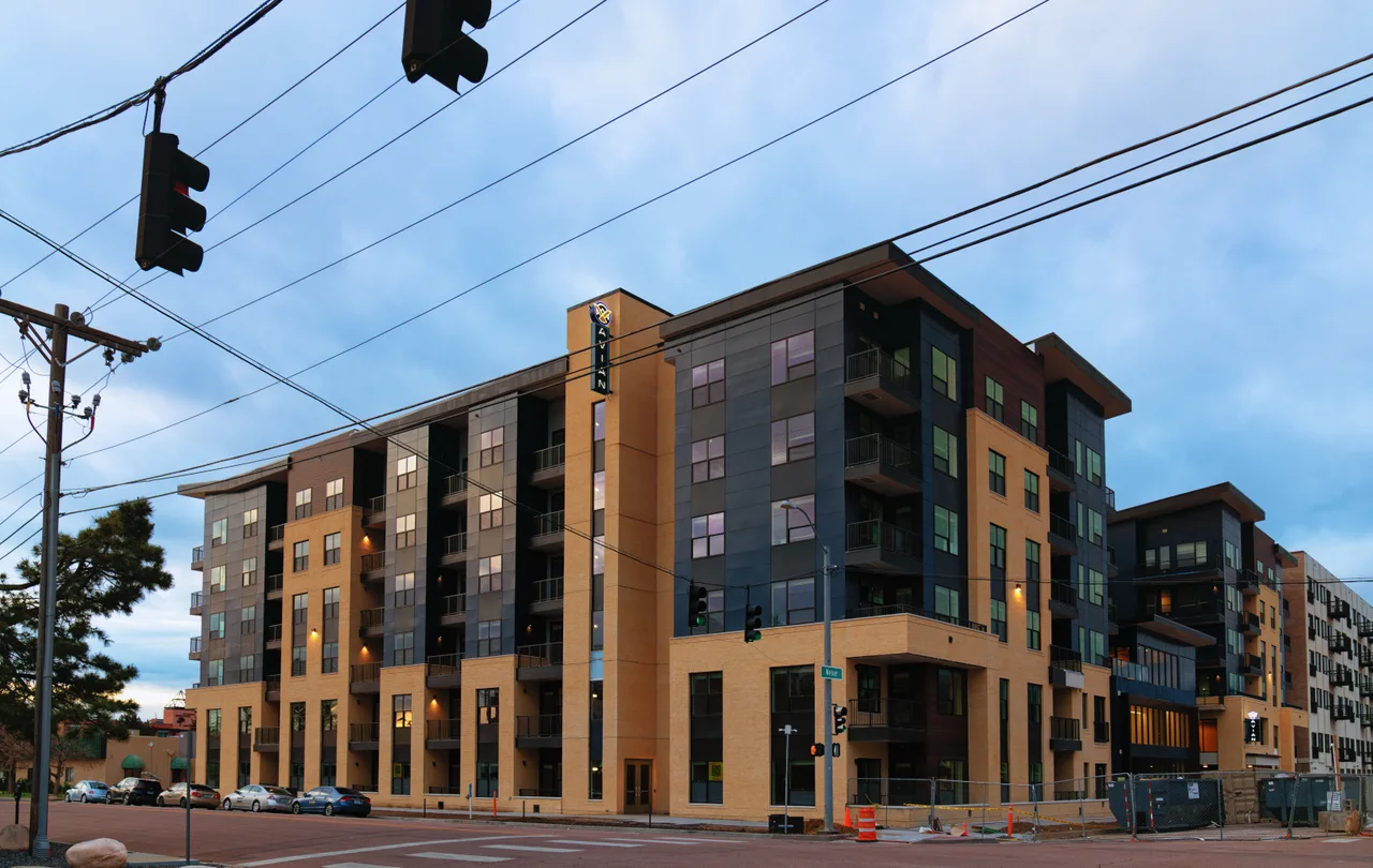 Multistory Avian apartment building with balconies at a Colorado Springs street corner