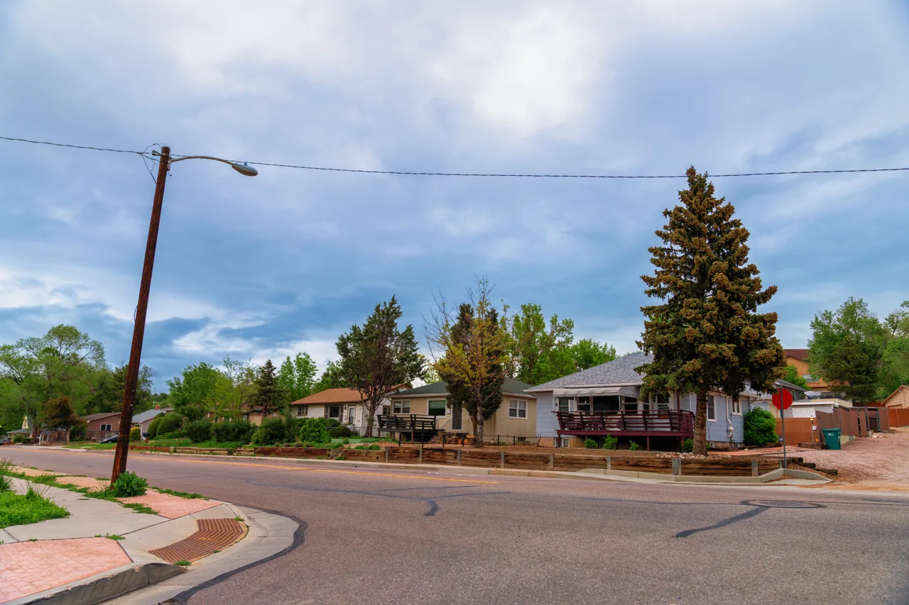 Low porch-front houses and trees along a street in Old Colorado City, Colorado Springs