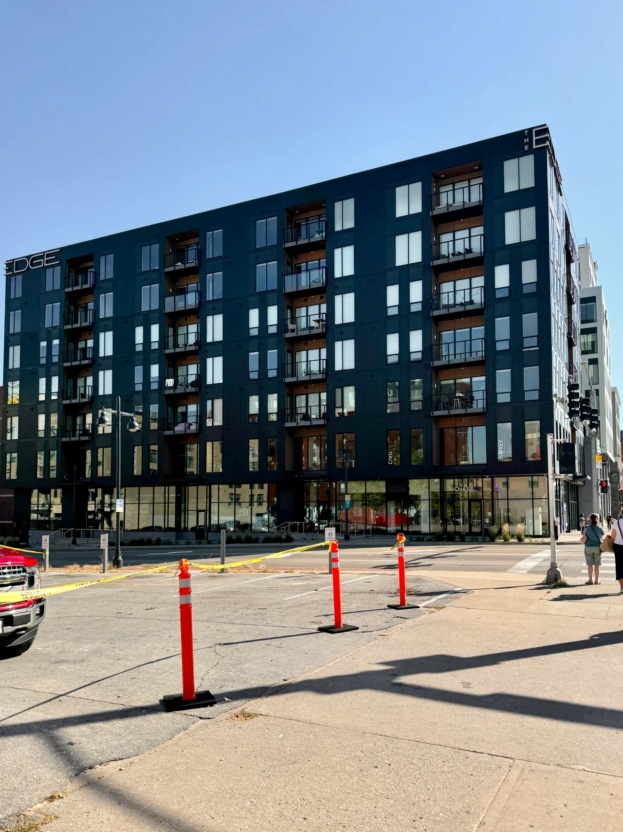 Dark multistory Edge condominium building above retail at Clinton and Burlington streets in Iowa City