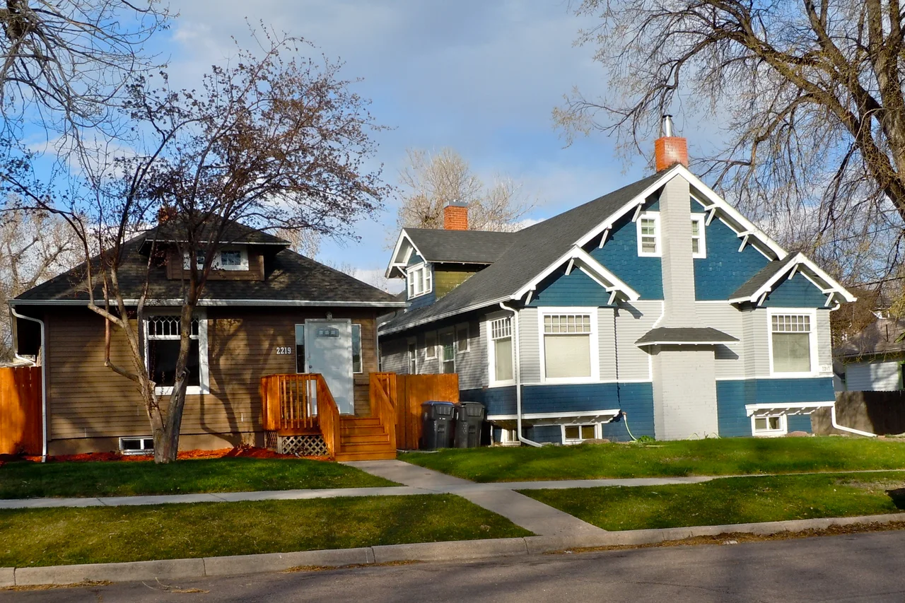 Two detached houses with gabled roofs and front porches in Cheyenne’s Lakeview district