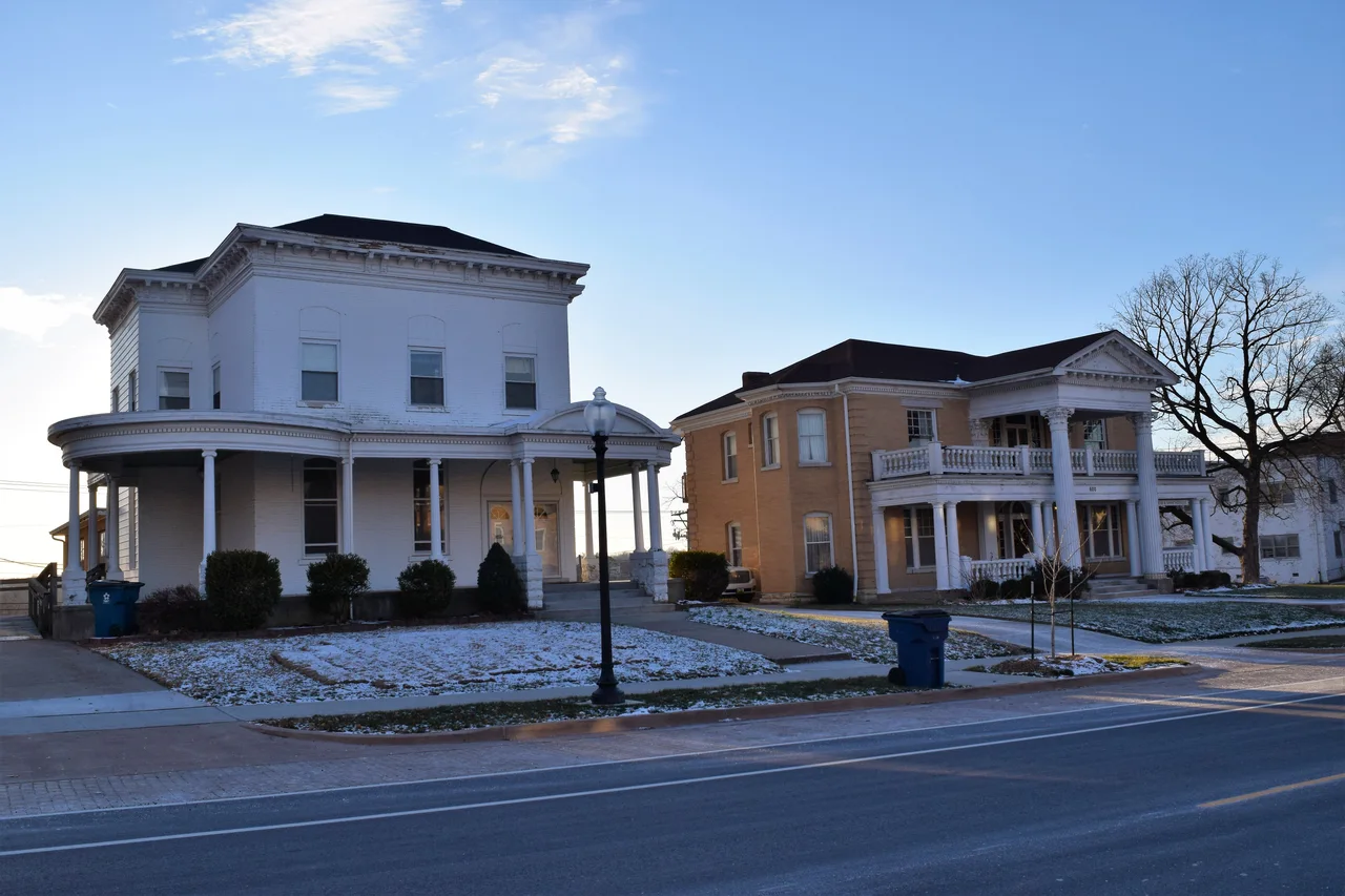 Two older houses with broad porches on East Capitol Avenue in Jefferson City