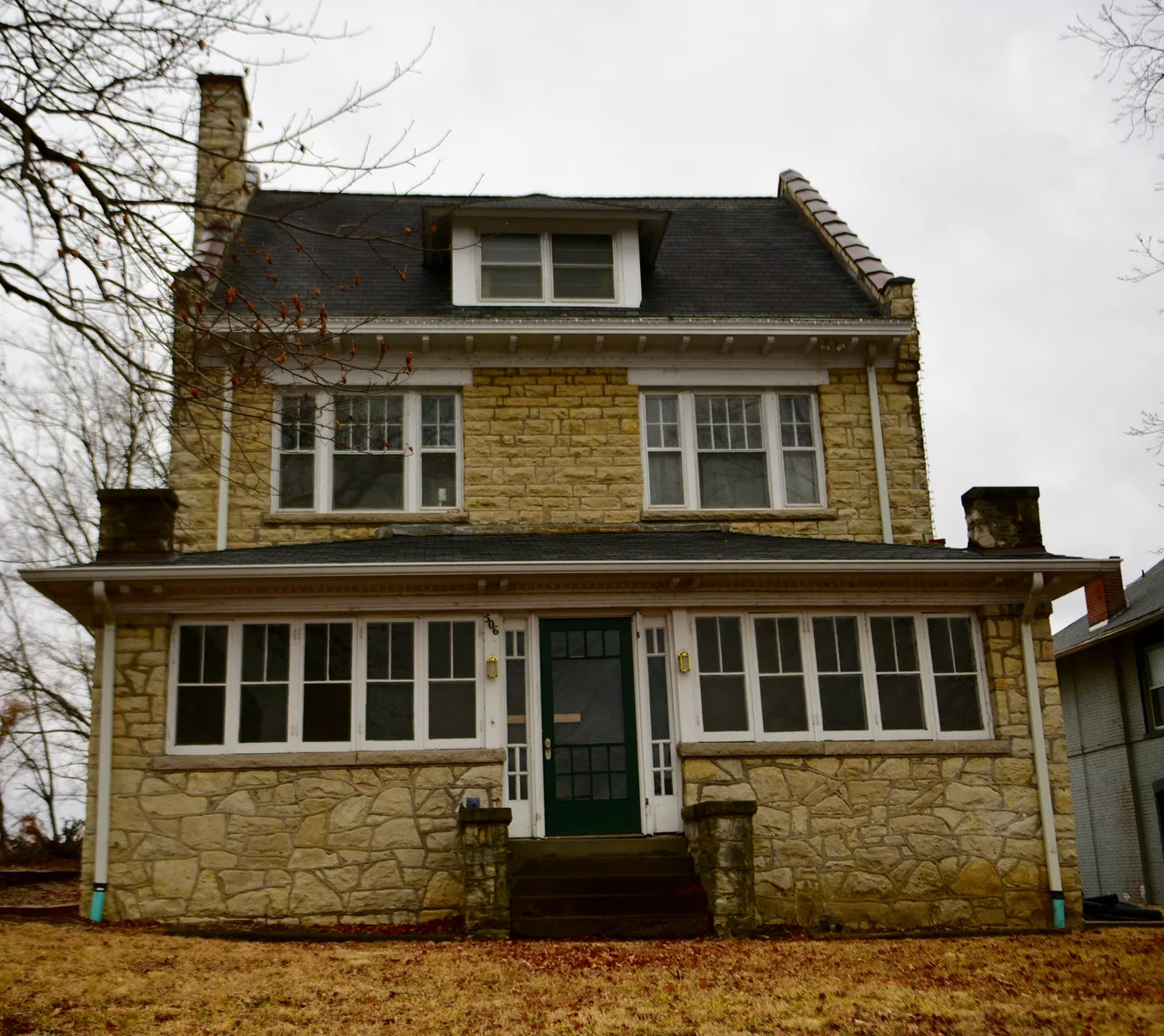 Stone house with a wide front porch and dormer at 506 East Miller in Jefferson City