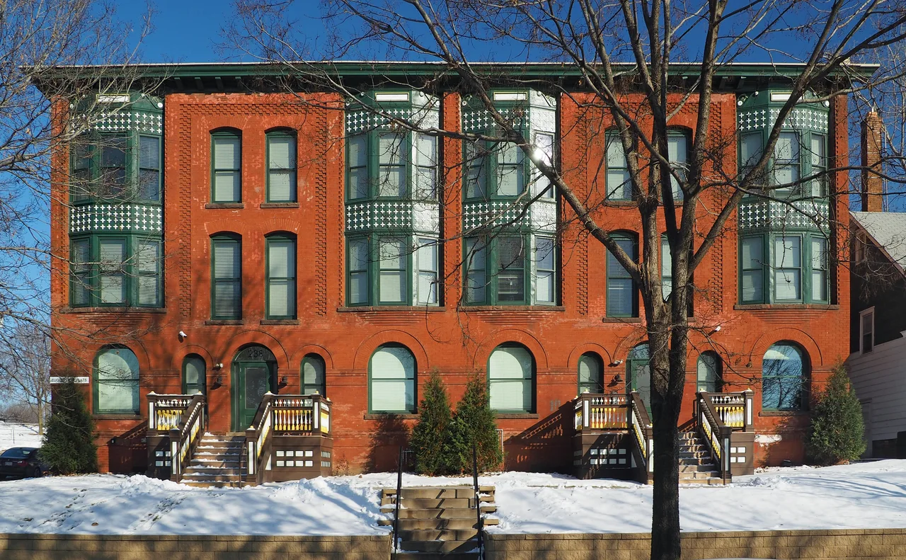 Brick Euclid View Flats with a corner turret on a snowy street in Saint Paul