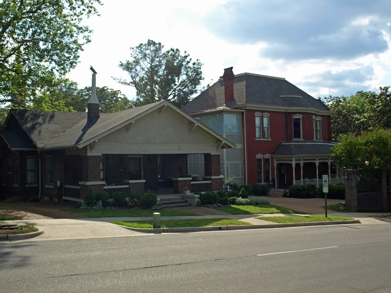 Porch-front houses behind trees along Lincoln Street in Huntsville’s Twickenham district