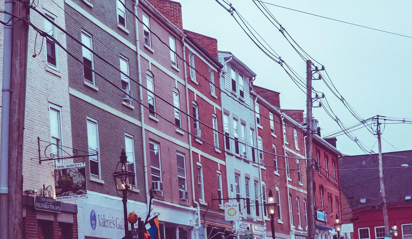 Brick facades and overhead utility lines on Market Street in Portsmouth